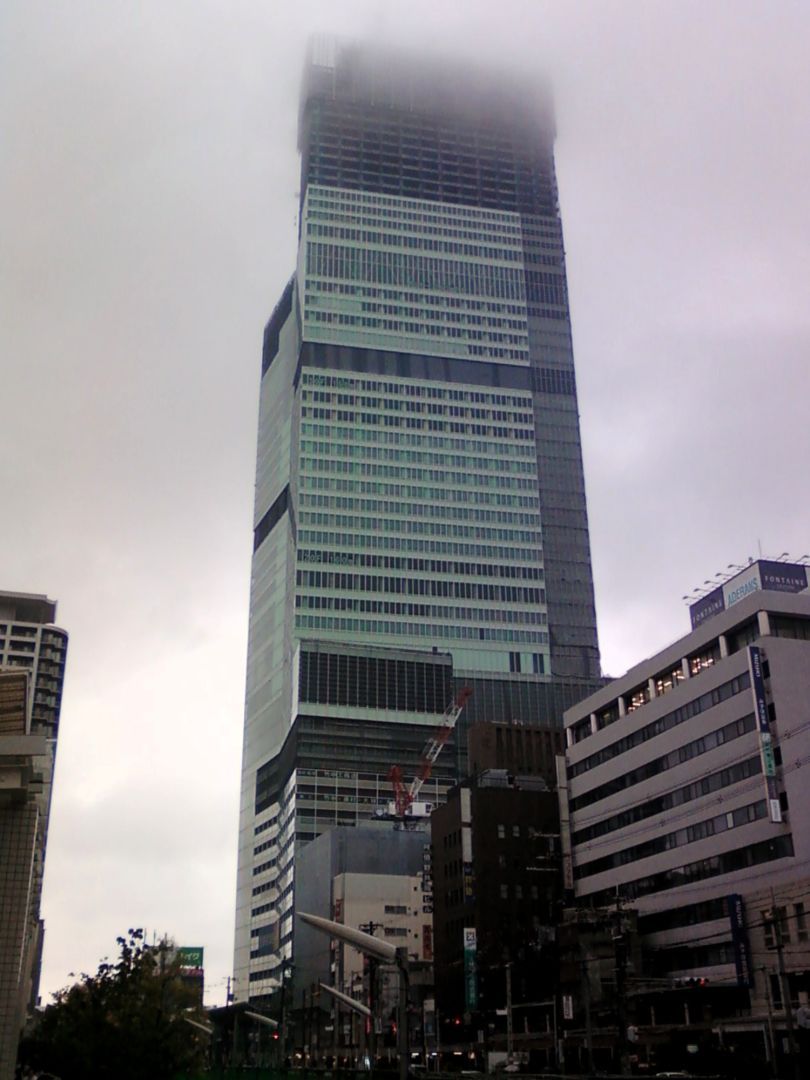 Tall building disappearing in the clouds